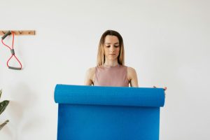 Changing habits - young woman holding a yoga mat