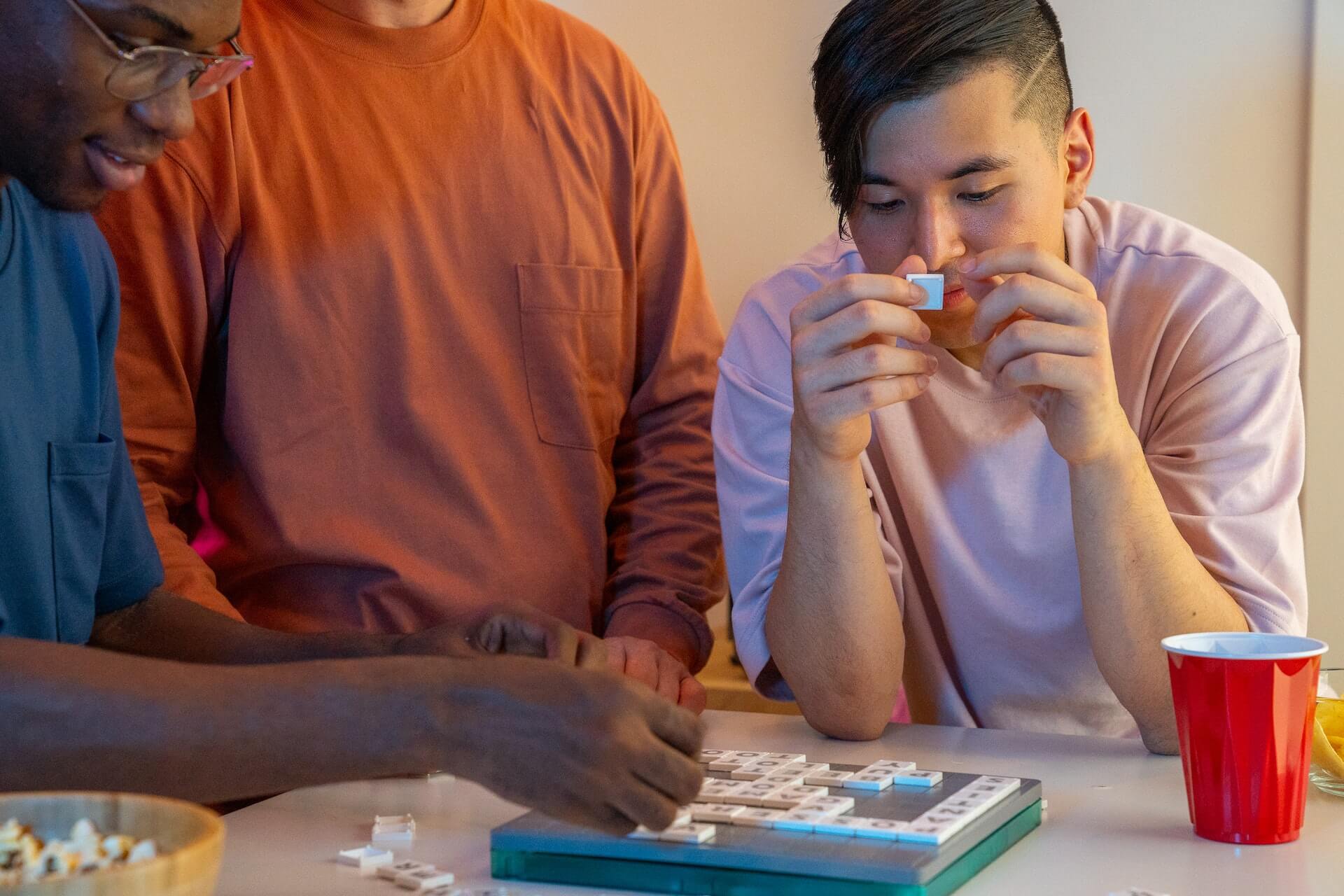 young adults playing scrabble